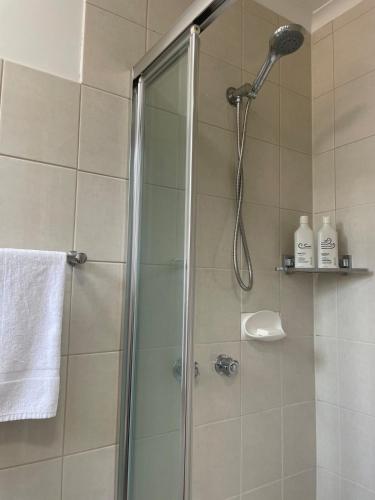 a shower with a shower head in a bathroom at Poppies Clunes in Clunes
