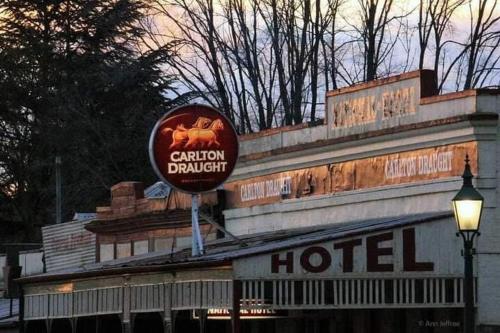a hotel sign on the side of a building at Poppies Clunes in Clunes