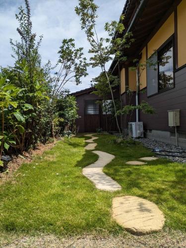 a walkway in front of a house at あその五岳 in Aso