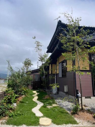 a house with a walkway in front of it at あその五岳 in Aso