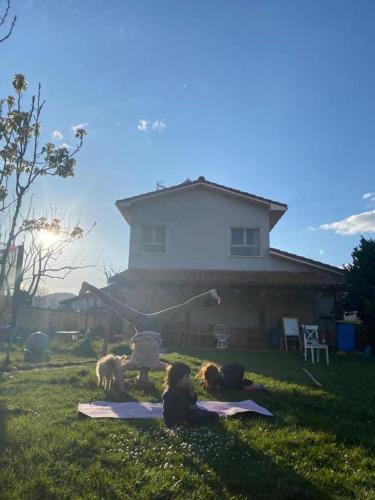 a woman doing a yoga pose in front of a house at Casita Azul Homestay in Cáseda