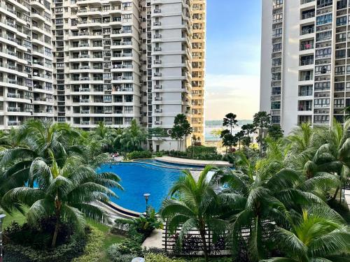 a pool in the middle of two tall buildings at DangaBay in CountryGarden - Fantastic2 #Cowidea in Johor Bahru