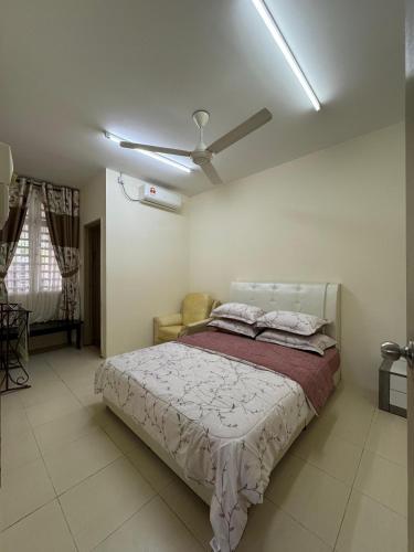 a bedroom with a bed and a ceiling fan at Adawiyah Guest House, Gambang in Gambang