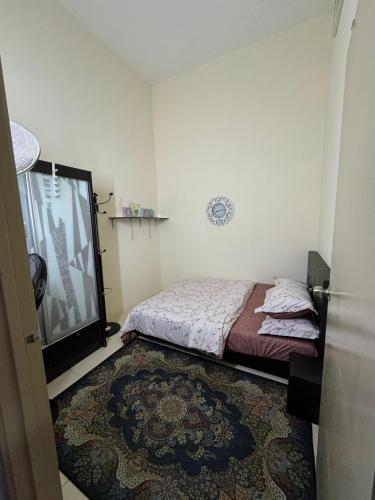a bedroom with a bed and a flat screen tv at Adawiyah Guest House, Gambang in Gambang