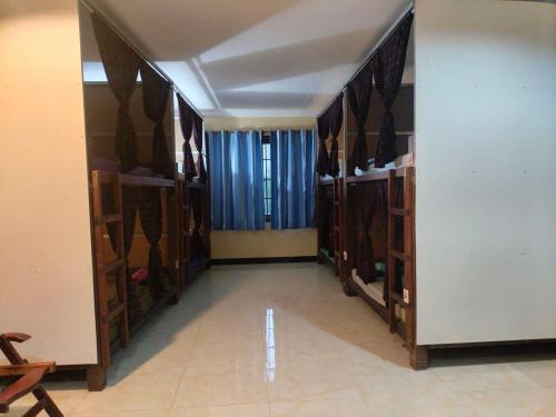 a room with many shelves in a room at Blue Diamond Hostel in Battambang