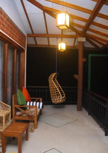 a living room with a couch and a swing at Rawana Mount View - Ella in Bandarawela