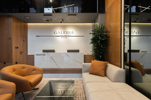 a lobby with a couch and chairs and a table at Garni Hotel Galeria in Banja Luka