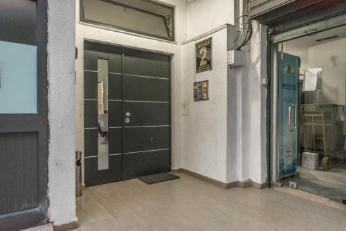 a garage with a green door in a building at Aria Apartment in Durrës