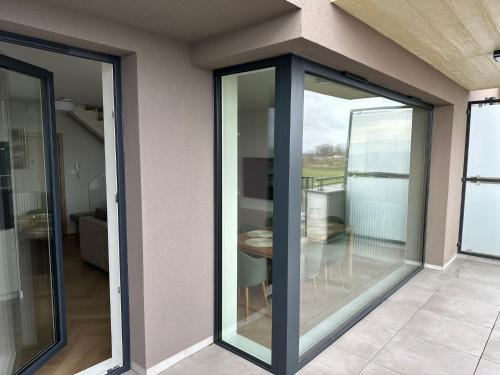 a room with sliding glass doors on a house at Apartament Premium Zamkowa B21 in Tczew