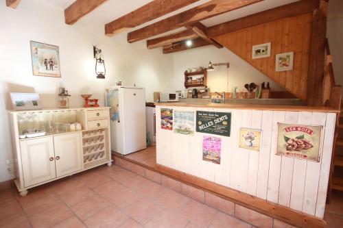 a kitchen with a counter and a refrigerator in a room at Le Moulin de Pensol - Bed and Breakfast in Pensol