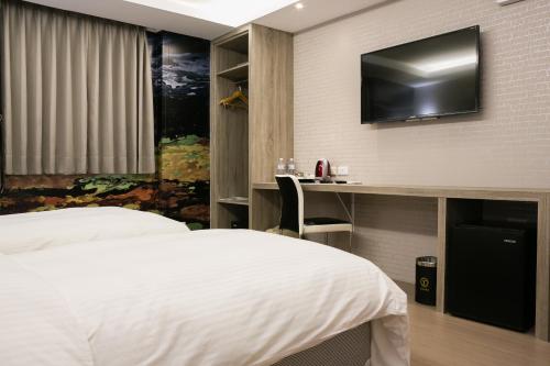 Ένα ή περισσότερα κρεβάτια σε δωμάτιο στο Yuhao Hotel - Hsinchu Branch