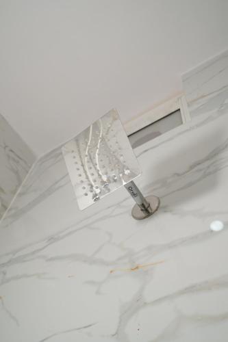 a lamp on top of a white ceiling at 2nd Homes in Dehradun