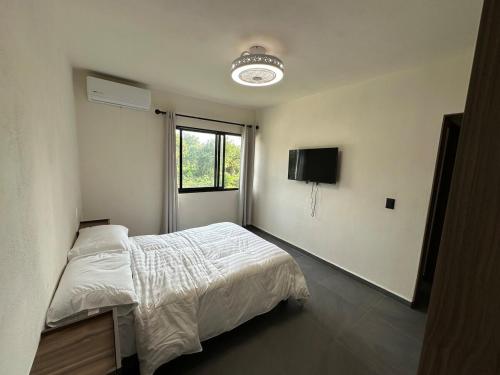 a bedroom with a bed and a television in it at Departamento en Puerto Vallarta in Puerto Vallarta