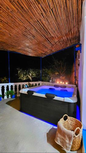a bedroom with a bed with a blue pool at Aegean Serenity - Sea View Retreat in Archangelos