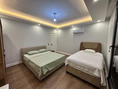 a bedroom with two beds in a room at Luxury Private Pool Villa C-Two in Aksu