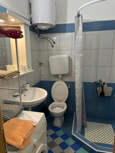 a bathroom with a toilet and a sink at Apartment S in Odžaci