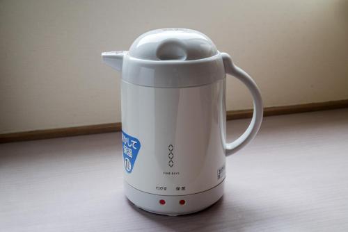 a white electric coffee maker sitting on a table at Taira View Hotel in Iwaki