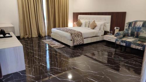 a bedroom with a bed and a marble floor at Clarks Safari Ranthambore in Khilchipur
