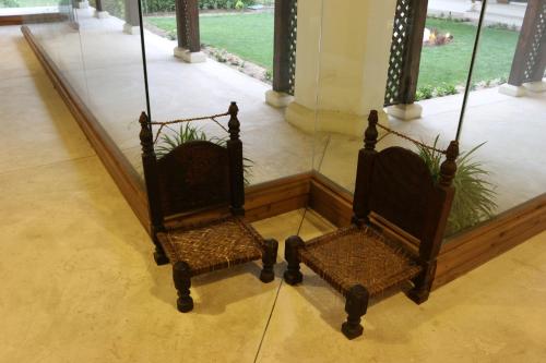 a couple of chairs sitting in a room at Swat Serena Hotel in Saidu