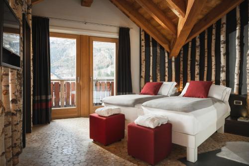 Posteľ alebo postele v izbe v ubytovaní Alpen Hotel Chalet