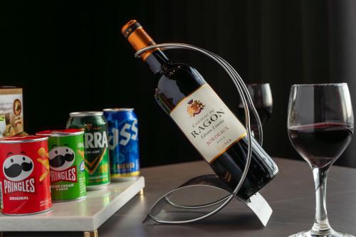 a bottle of wine and a glass on a table at Eliena Hotel Seoul Gangnam in Seoul