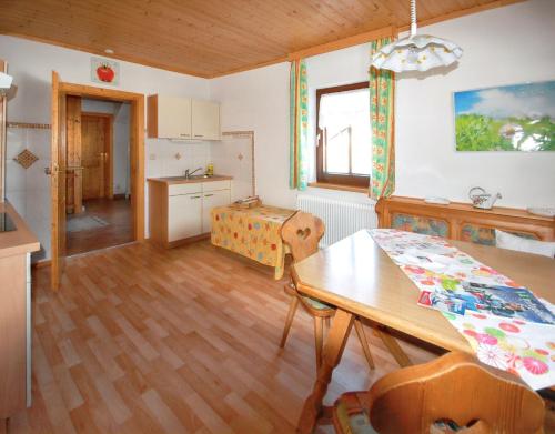 a kitchen and living room with a table and a dining room at Charming House in Pruggern, Mountain View in Pruggern