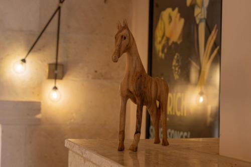 a wooden toy giraffe sitting on top of a table at Asmalı Konak Cave Suites in Urgup
