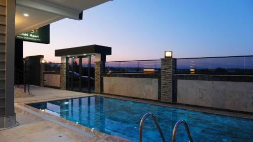 a swimming pool on the roof of a building at Krabi Apart in Lara