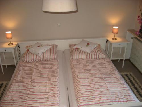2 Betten in einem Zimmer mit zwei Lampen in der Unterkunft Ferienwohnung Anneliese Eckhart in Anger