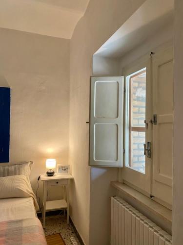 a bedroom with a bed and a window at Casa contadina nel verde ai piedi della Majella - Agricasa Caprafico in Casoli
