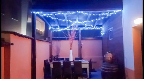 a room with a table with chairs and lights at Maruffi 17 zona clinica bilocali in Piacenza