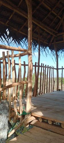 a wooden deck with a wooden fence on the beach at Mamba Yala in Tissamaharama
