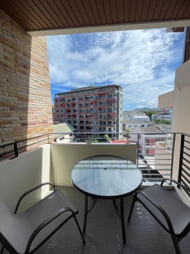a table and chairs on a balcony with a view at My PLACE HUA-HIN HOTEL in Hua Hin