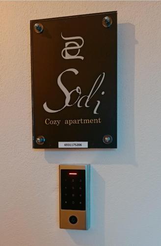 a sign for a gay appointment hanging on a wall at Sodi Cozy apartment in Kardítsa