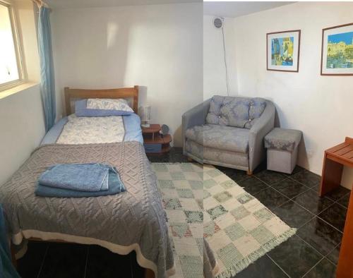 a bedroom with a bed and a couch and a chair at Millies Place in Elkhovo