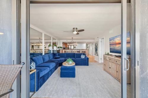a living room with a blue couch and a table at Chadham by the Sea 413 in New Smyrna Beach