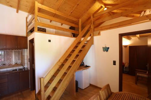 a loft bed in a kitchen with a staircase at Ontas Traditional Apartment In Gavalochori - BY APOKORONAS VILLAS in Gavalochori