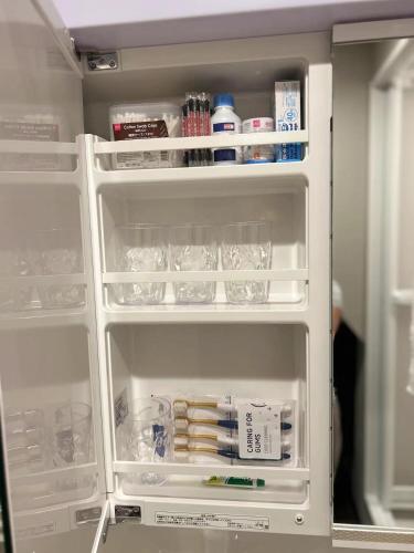 an open refrigerator with its door open and food inside at 悦然民宿-天下茶屋 in Osaka