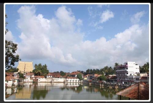 a view of a river with houses and buildings at VASUDEVA VILASAM Health Retreat in Trivandrum
