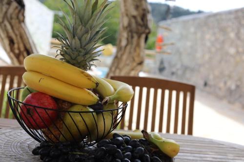 a bowl of bananas and fruit on a table at Ontas Traditional Apartment In Gavalochori - BY APOKORONAS VILLAS in Gavalochori