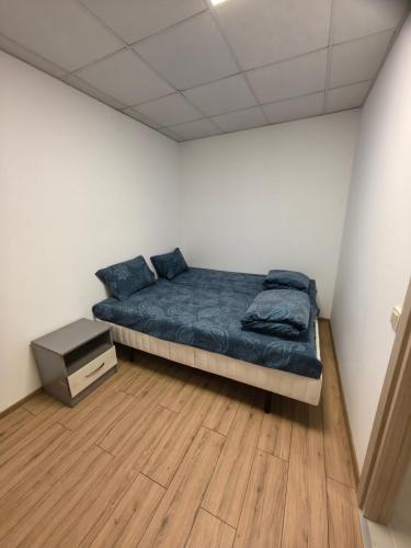 a bedroom with a bed and a wooden floor at Apartament Bellisimo in Sofia