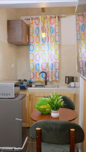 a kitchen with a table with a bowl of fruit on it at GNj HOMES in Sisa