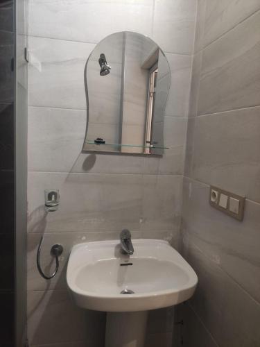 a bathroom with a sink and a mirror at Mounia Moon in Casablanca