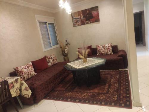 a living room with a couch and a table at Mounia Moon in Casablanca