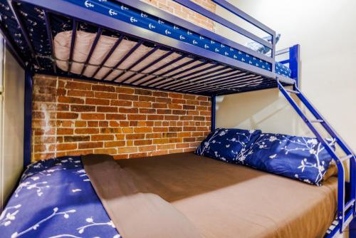 a bunk bed in a room with a brick wall at Studios in New York in New York
