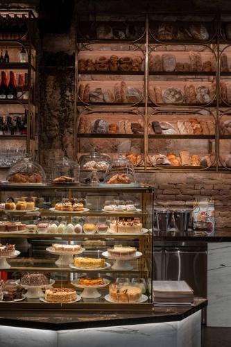a display case in a bakery with many different pastries at Hotel Donald in Odesa