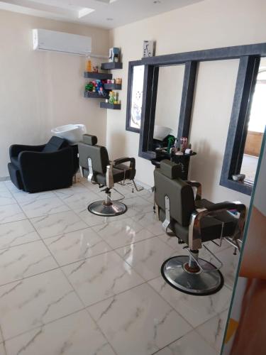 a living room with chairs and a hair salon at Beach safari nubian resort in Marsa Alam City