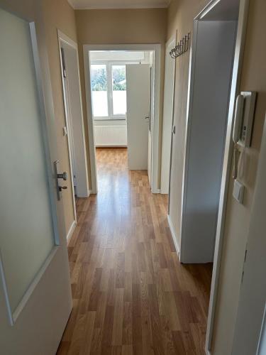 an empty hallway of an apartment with a wooden floor at Fewo-H41 in Korschenbroich