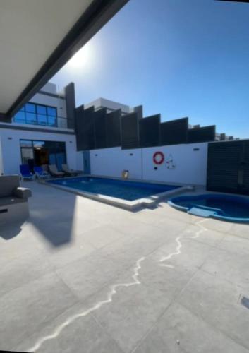 a view of a building with a swimming pool at The Riviera Luxury Villa - Seaview Al Dana Fujairah in Fujairah