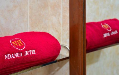 a red towel is sitting on a shelf at Ndanga Hotel in Ruiru